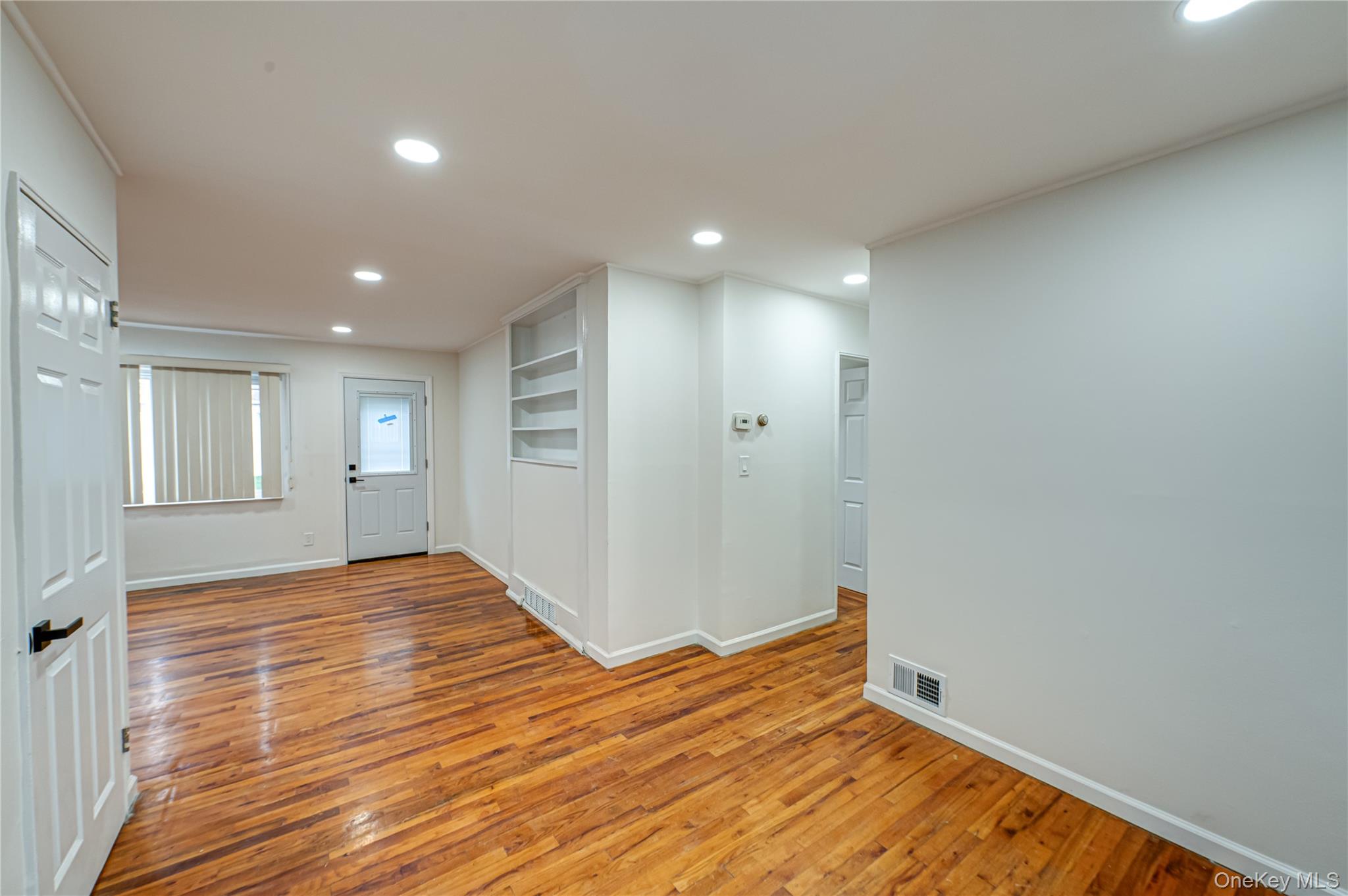 10 Gerhard Road Plainview, NY 11803 - Photo 3 of 13 a view of empty room with wooden floor