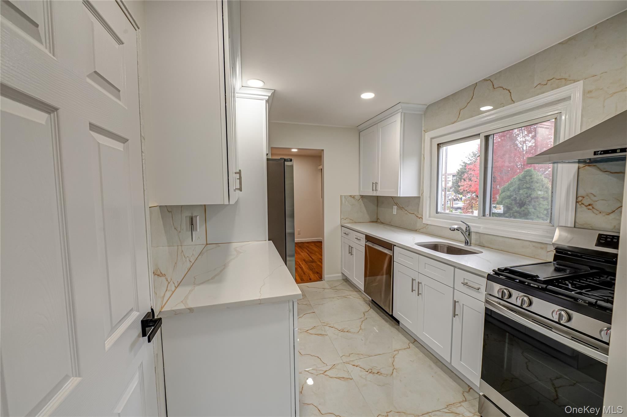 10 Gerhard Road Plainview, NY 11803 - Photo 4 of 13 a large kitchen with stainless steel appliances granite countertop a sink stove and refrigerator
