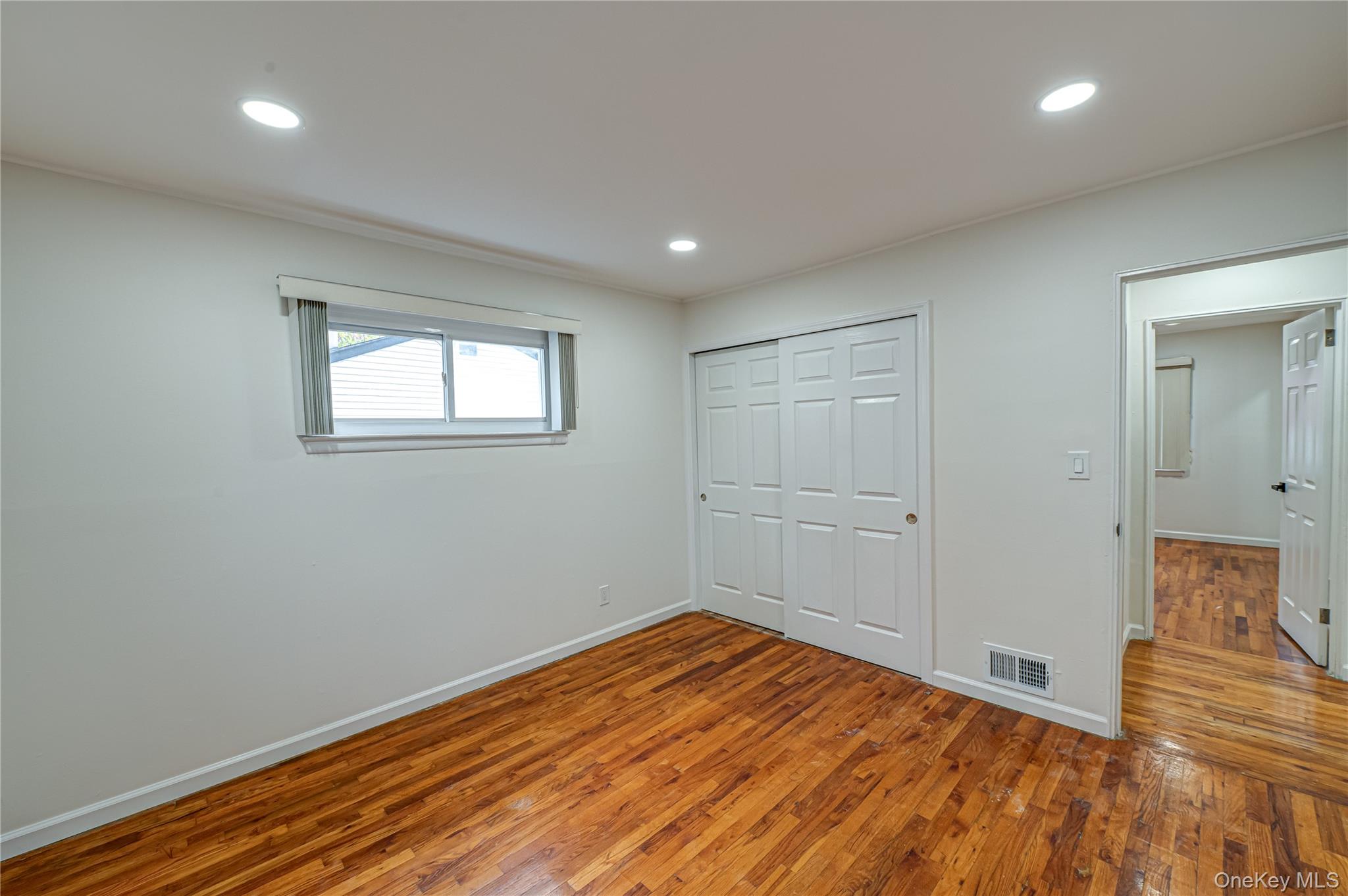 10 Gerhard Road Plainview, NY 11803 - Photo 8 of 13 a view of empty room with wooden floor