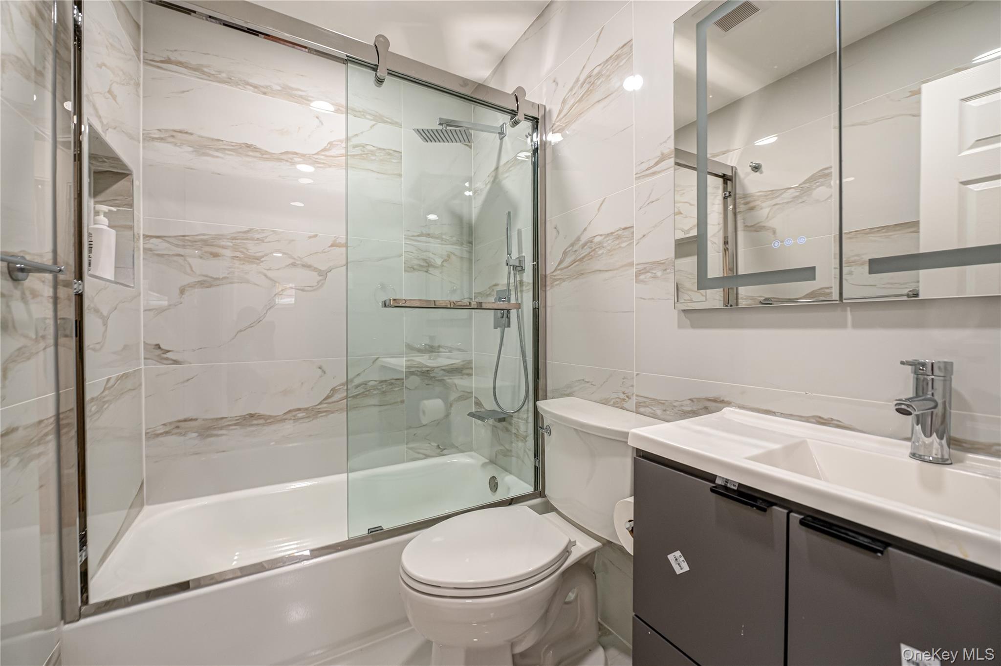 10 Gerhard Road Plainview, NY 11803 - Photo 9 of 13 a bathroom with a sink toilet and shower