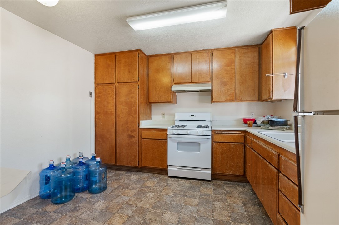 6079 La Prada Los Angeles, CA 90042 - Photo 23 of 32 a kitchen with stainless steel appliances granite countertop a sink stove and refrigerator