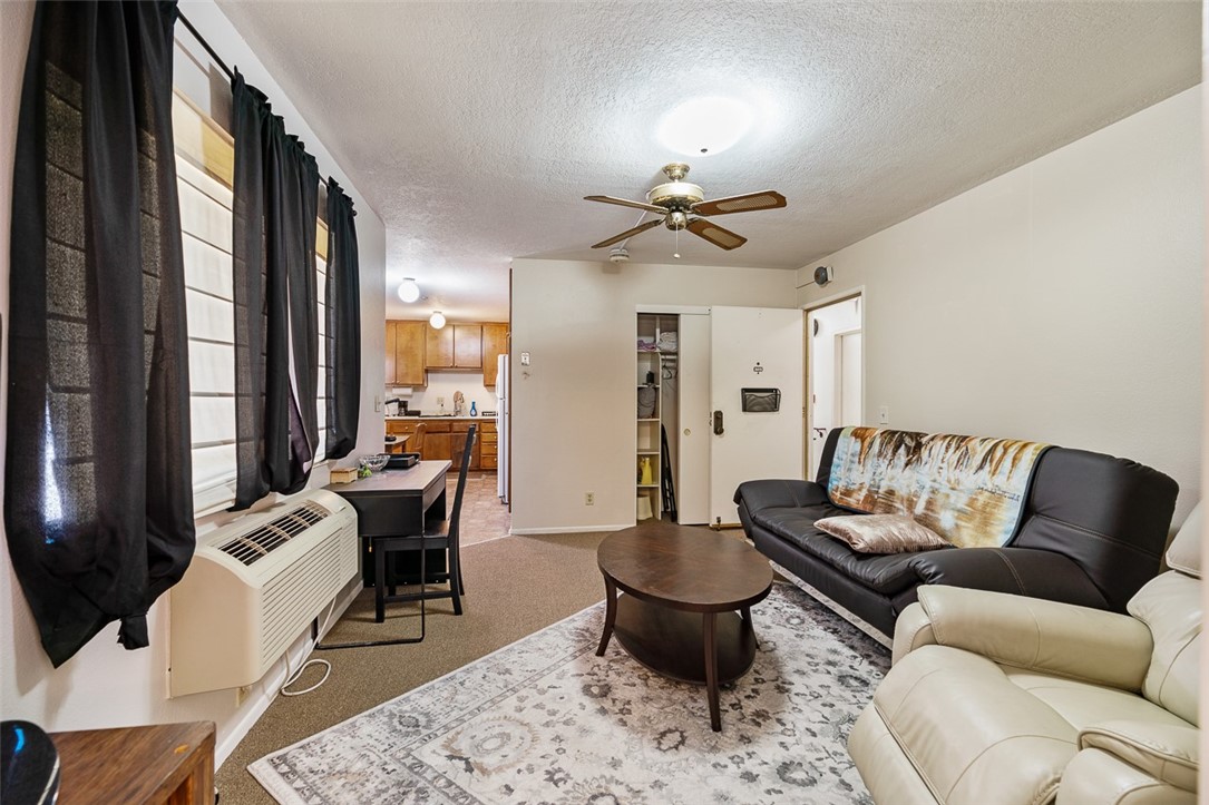 6079 La Prada Los Angeles, CA 90042 - Photo 8 of 32 a living room with furniture ceiling fan and a rug