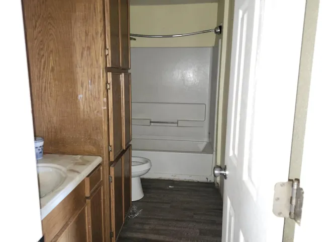 a bathroom with a granite countertop shower and a sink