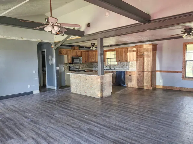 a view of a kitchen with a sink and wooden floor