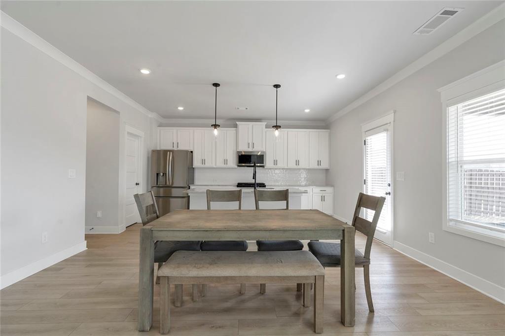 5316 Milford Road Gainesville, GA 30507 - Photo 16 of 44 a kitchen with a table chairs microwave and cabinets