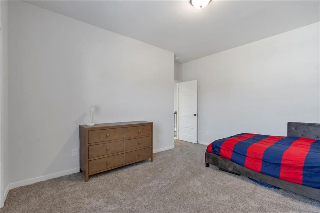 5316 Milford Road Gainesville, GA 30507 - Photo 34 of 44 a bedroom with a bed and lamp