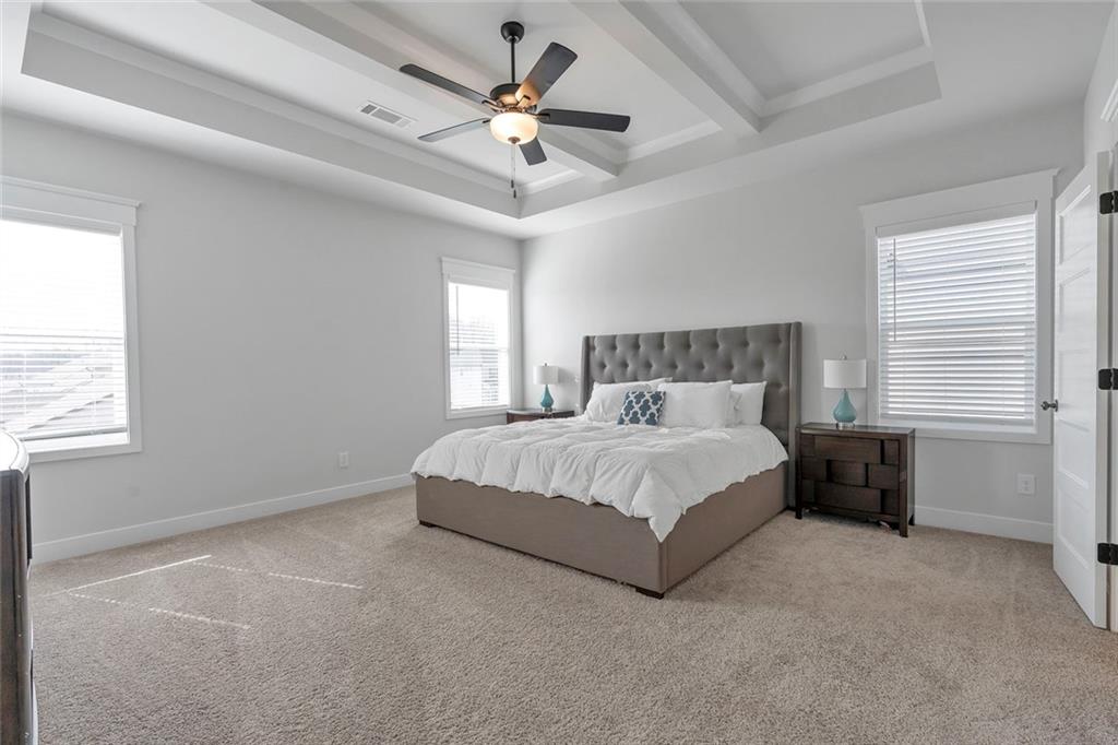 5316 Milford Road Gainesville, GA 30507 - Photo 37 of 44 a spacious bedroom with a bed and a chandelier