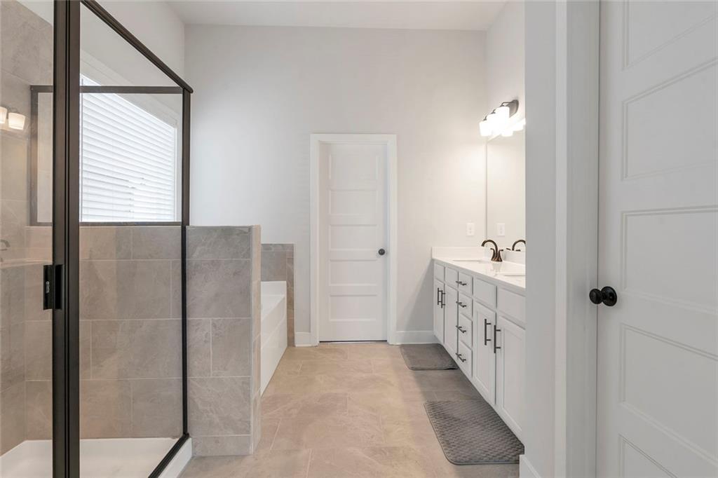 5316 Milford Road Gainesville, GA 30507 - Photo 40 of 44 a bathroom with a double vanity sink and mirror