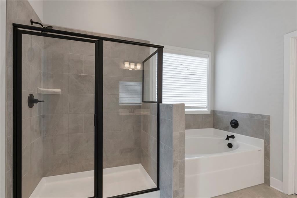 5316 Milford Road Gainesville, GA 30507 - Photo 41 of 44 a bathroom with a bathtub and shower