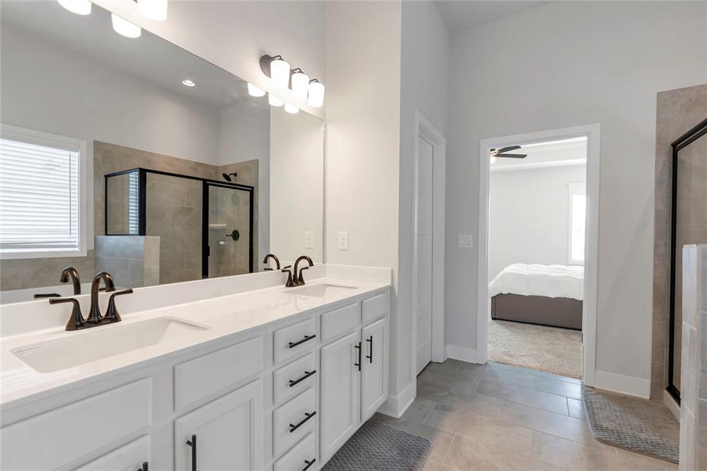 5316 Milford Road Gainesville, GA 30507 - Photo 42 of 44 a en suite bathroom with double sink and a mirror