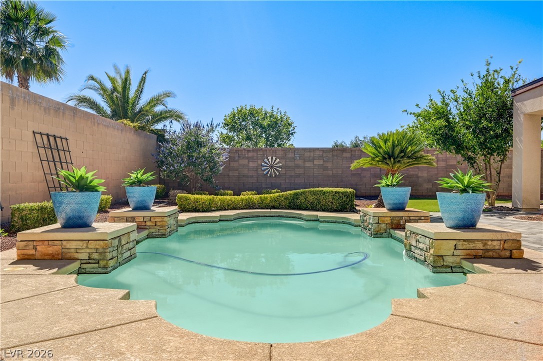 2793 Rosenhearty Drive Henderson, NV 89044 - Photo 64 of 85 Relax poolside in this serene backyard oasis, perfect for warm-weather enjoyment.