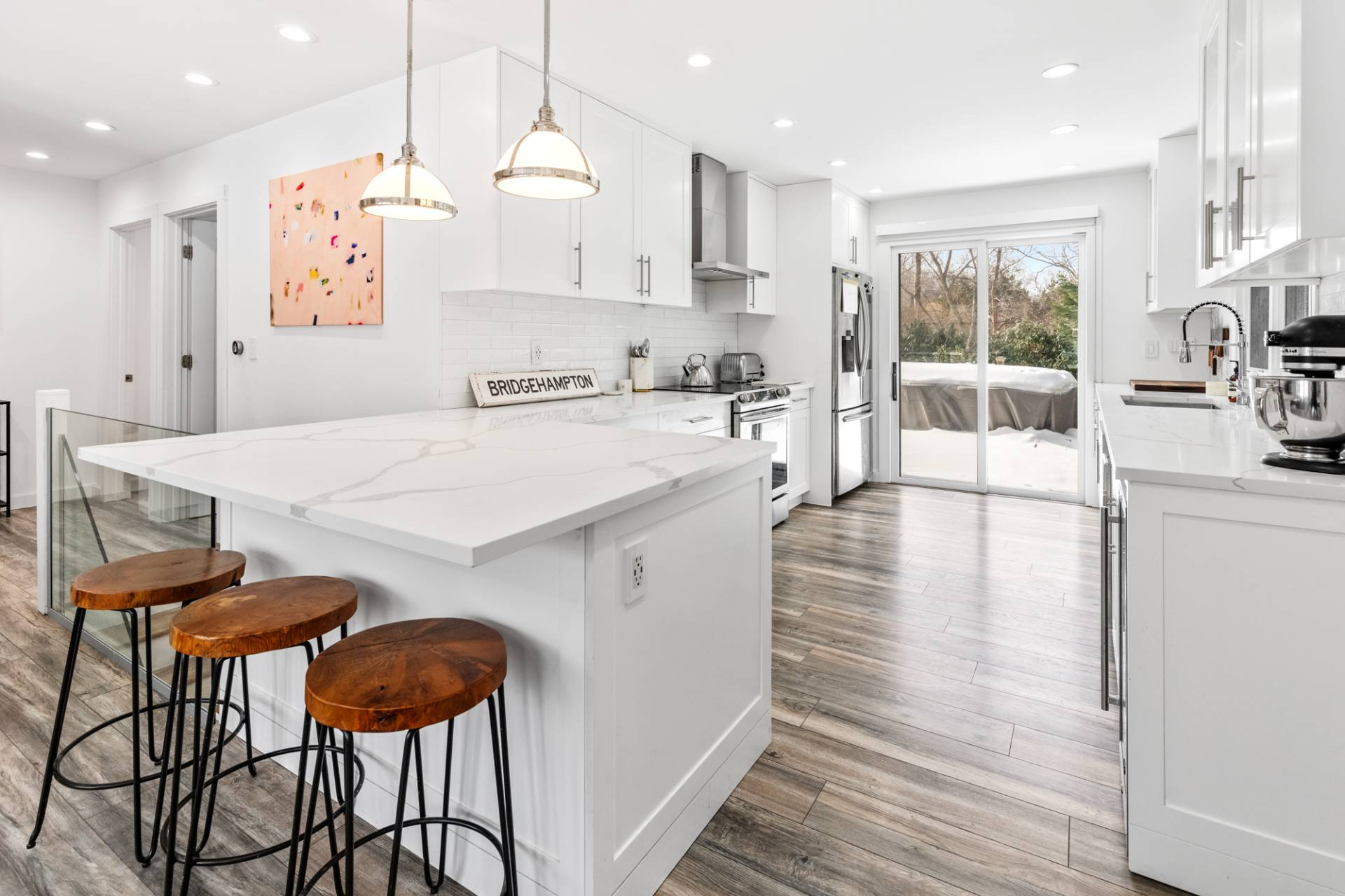 778 Bridgehampton Sag Harbor Bridgehampton, NY 11932 - Photo 7 of 18 a kitchen with stainless steel appliances kitchen island granite countertop a table chairs sink and cabinets