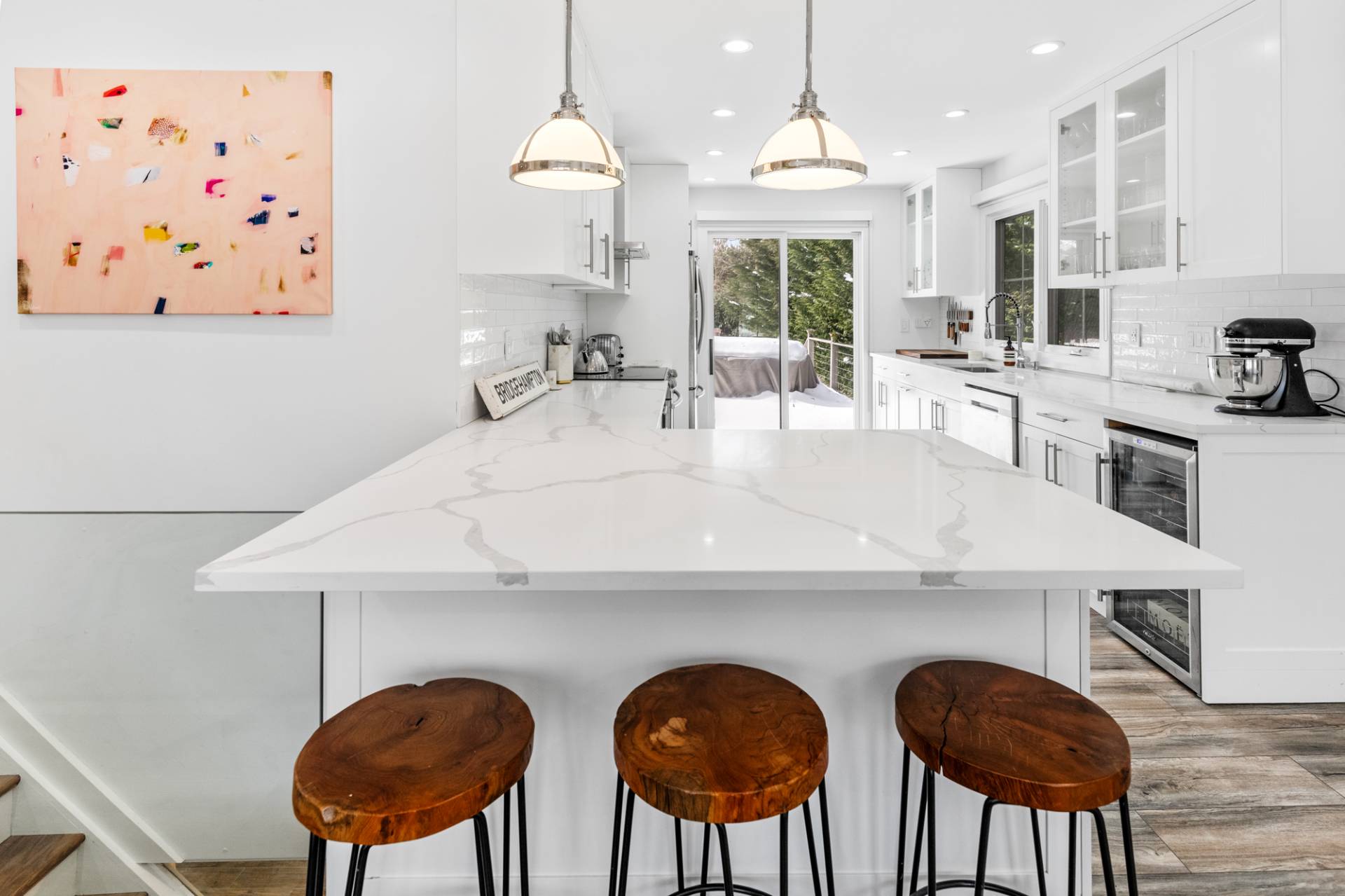 778 Bridgehampton Sag Harbor Bridgehampton, NY 11932 - Photo 8 of 18 a kitchen with stainless steel appliances a table chairs and a refrigerator