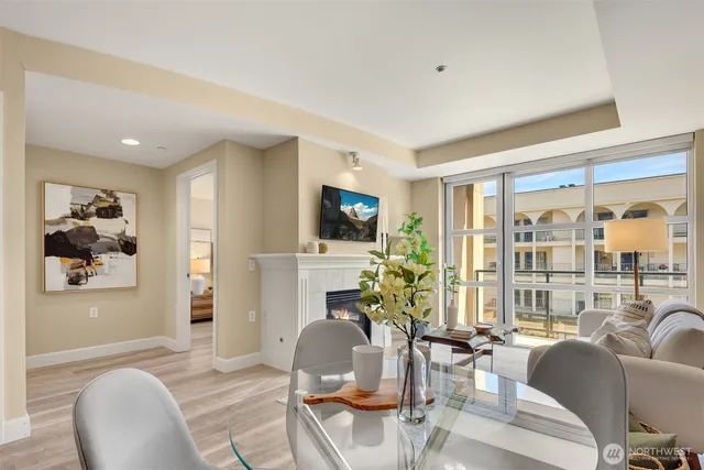 a living room with furniture a flat screen tv and a large window
