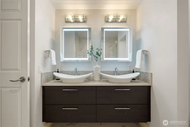 a bathroom with a double vanity sink and mirror
