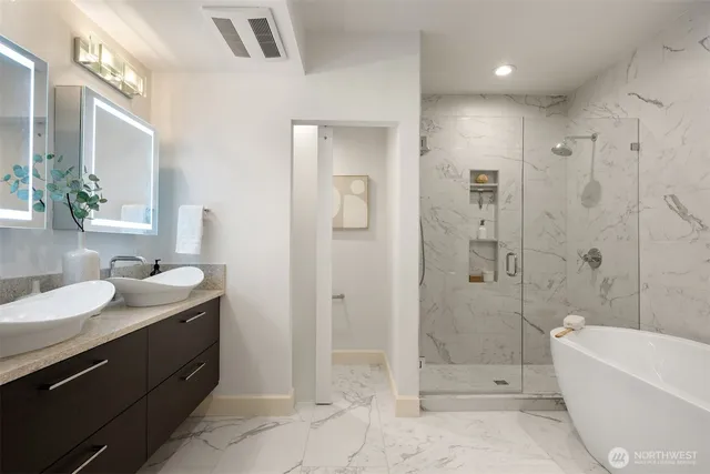 a spacious bathroom with a granite countertop sink mirror and shower