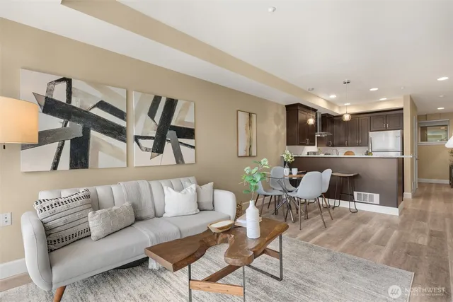 a living room with furniture and kitchen view