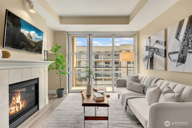 a living room with furniture a flat screen tv and a fireplace