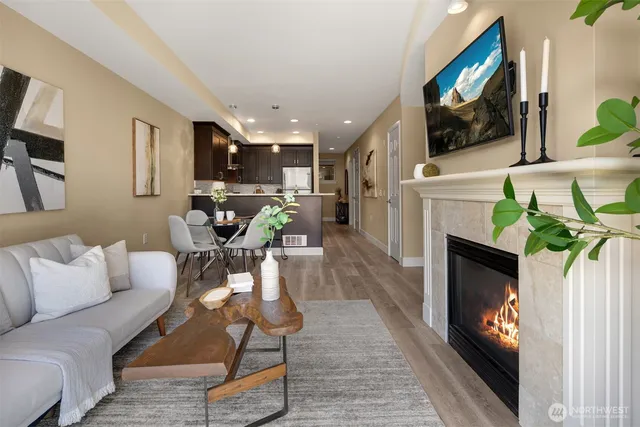 a living room with furniture a flat screen tv and a fireplace