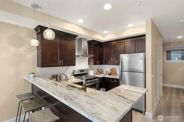 a kitchen with refrigerator cabinets and wooden floor