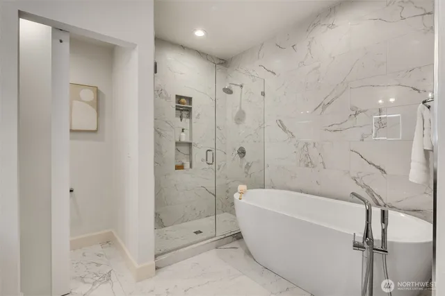 a bathroom with a bathtub and shower