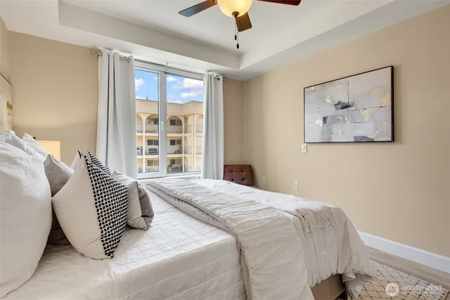 a bedroom with a large bed and a large window