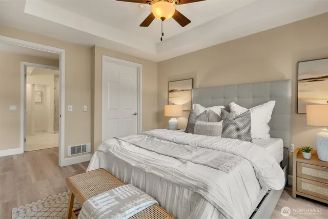 a spacious bedroom with a bed and a chandelier