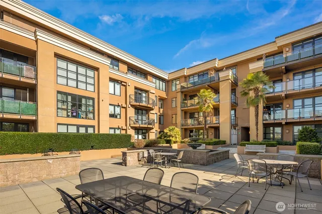 a view of a patio with couches table and chairs and potted plants
