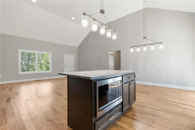 an open kitchen with sink and microwave
