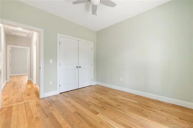 a bathroom with a granite countertop sink a toilet and a window