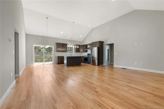 a view of a kitchen with a kitchen counter top space and wooden floor