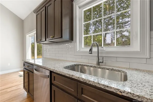 a kitchen with granite countertop a sink and a window