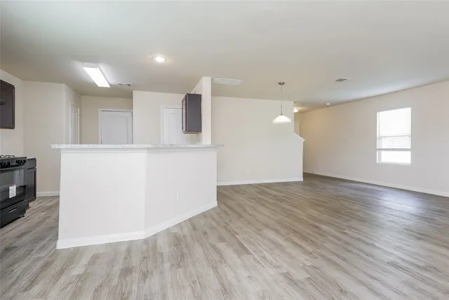 a view of kitchen with wooden floor and electronic appliances