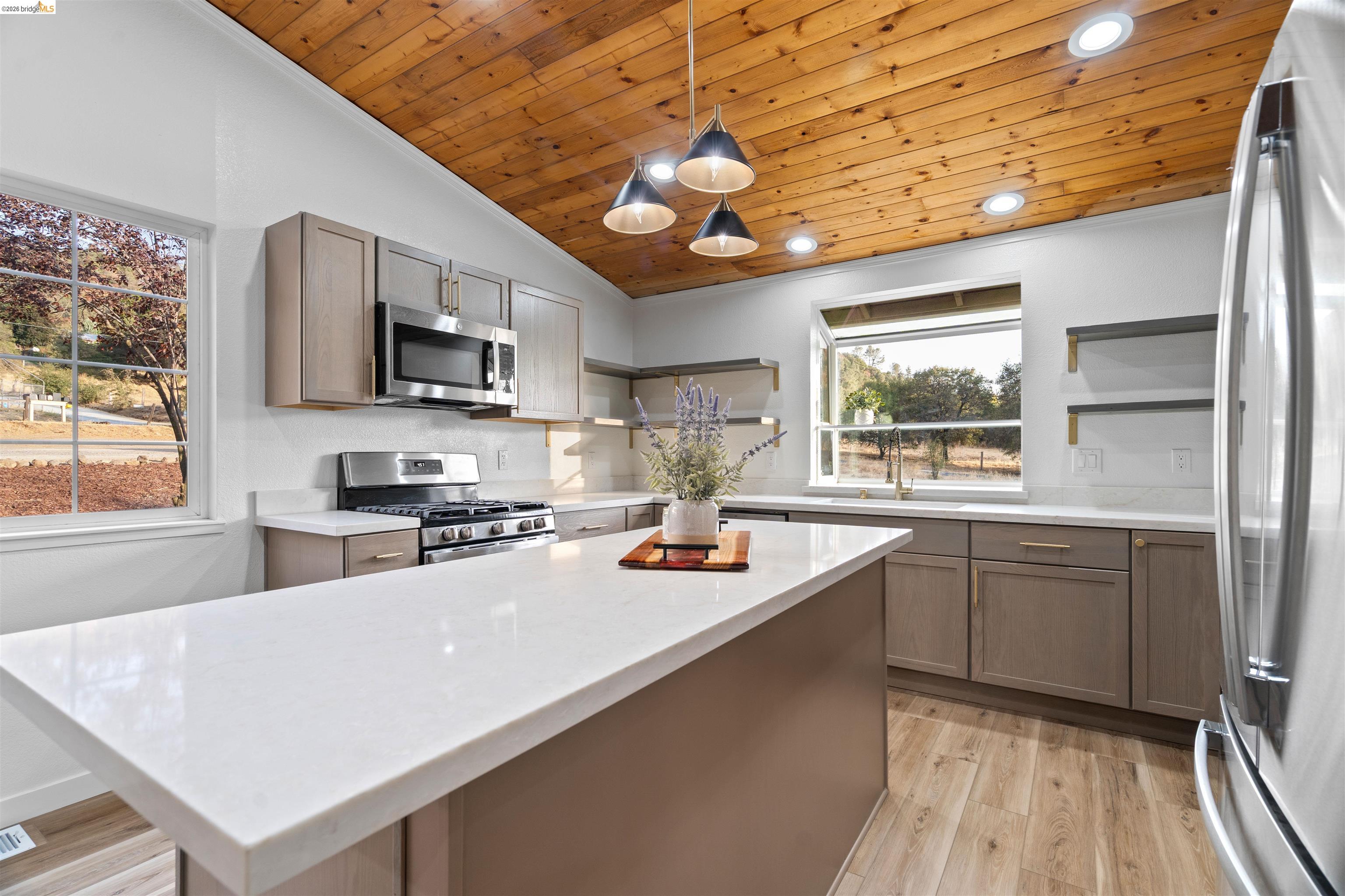19676 Rawhide Road Sonora, CA 95370 - Photo 16 of 67 Vaulted wood-paneled ceiling, recessed lighting, and a white quartz-finish island