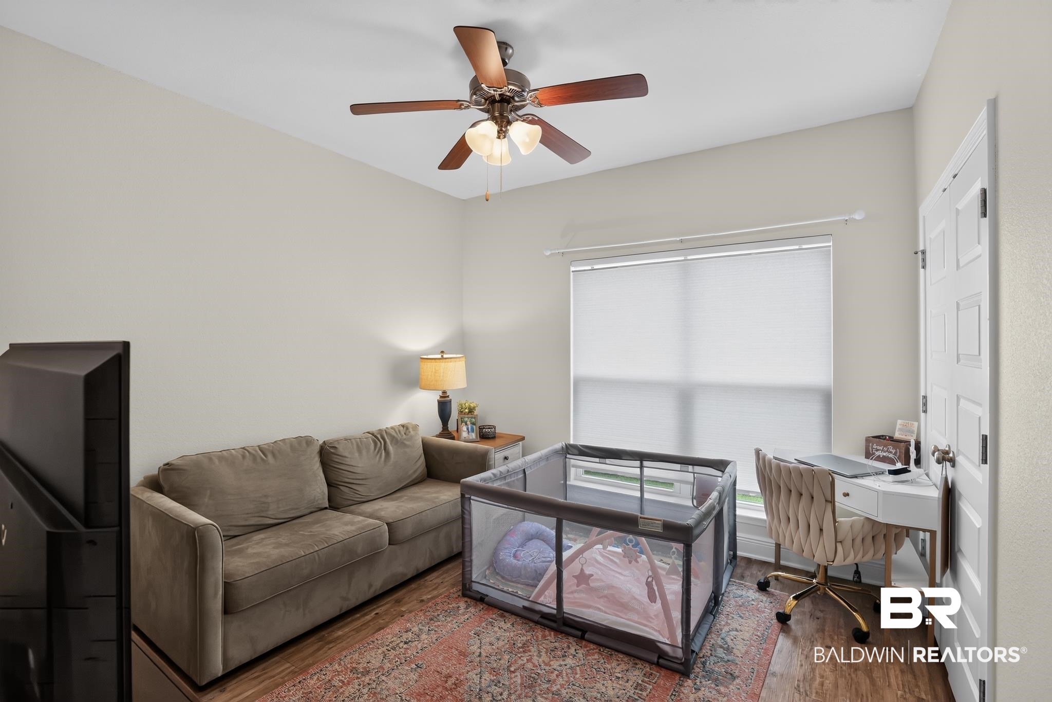 1210 Primrose Lane Foley, AL 36535 - Photo 24 of 33 Spacious room with wood-finish flooring, a vaulted ceiling, and a ceiling fan with integrated lighting