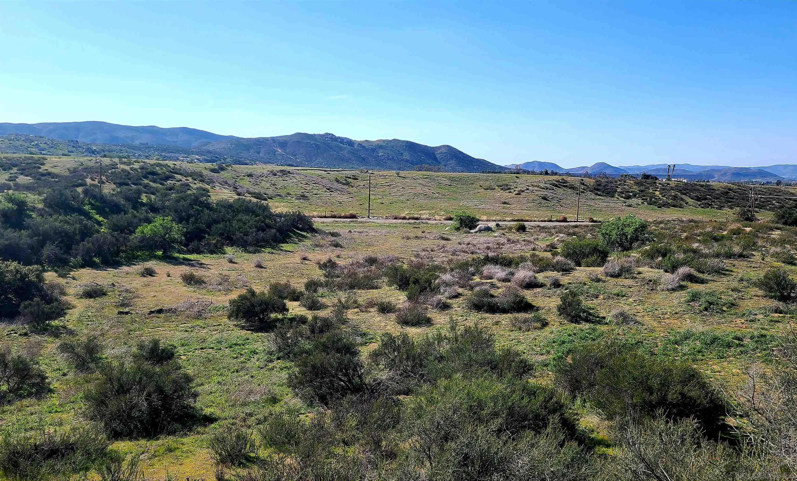 31732 Sage Road Hemet, CA 92544 - Photo 4 of 5 a view of a lush green field with mountains in the background