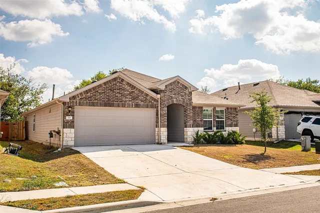 a view of a house with snow on the side of the road