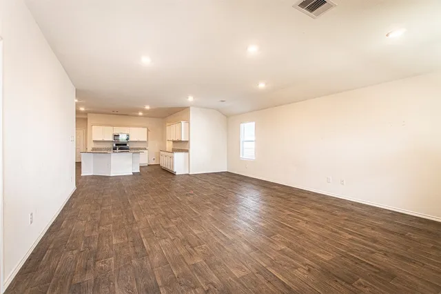 a backyard of a house with table and chairs