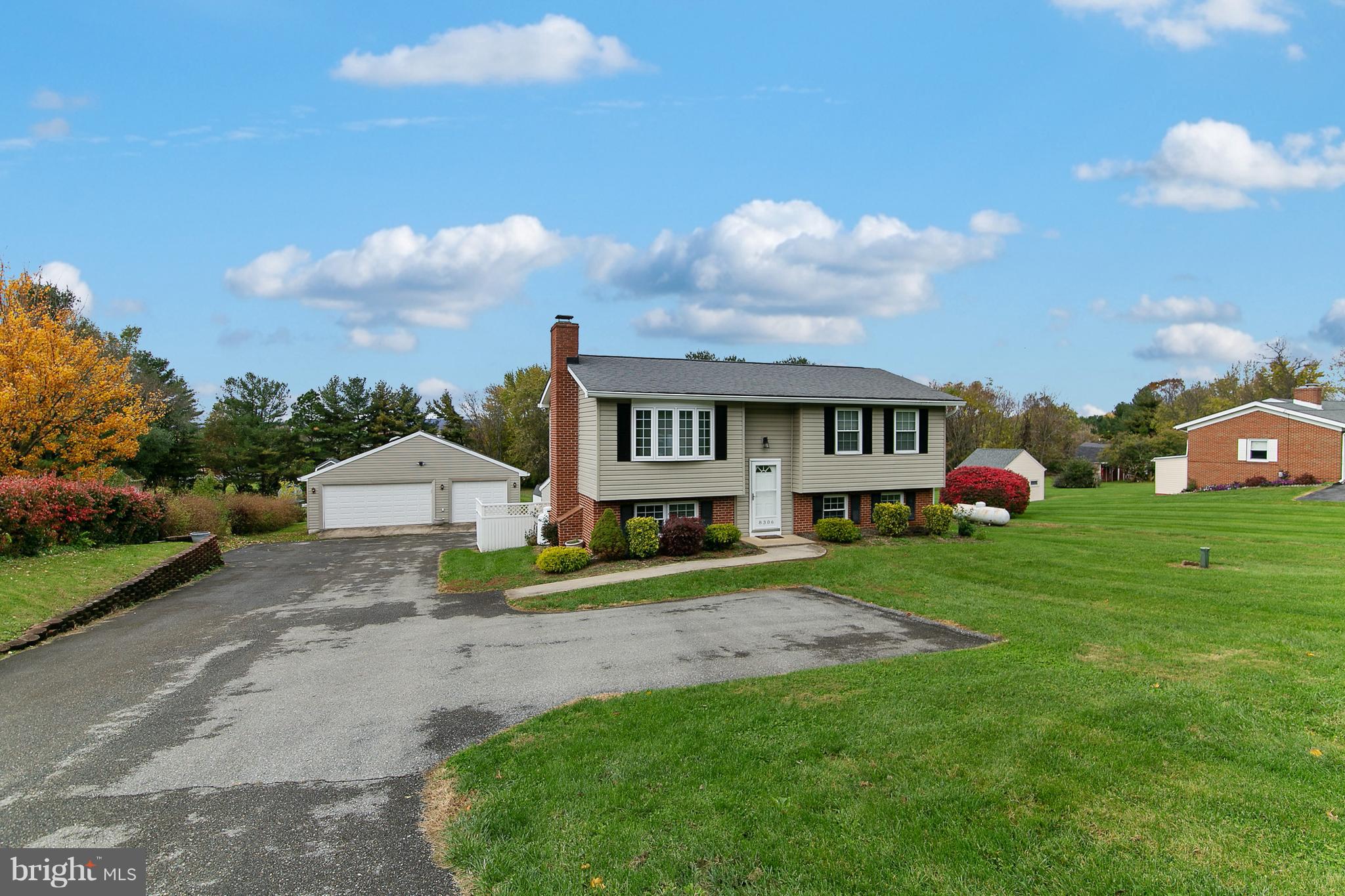 8306 Hollow Road Middletown, MD 21769 - Photo 1 of 37 a front view of a house with a garden and trees