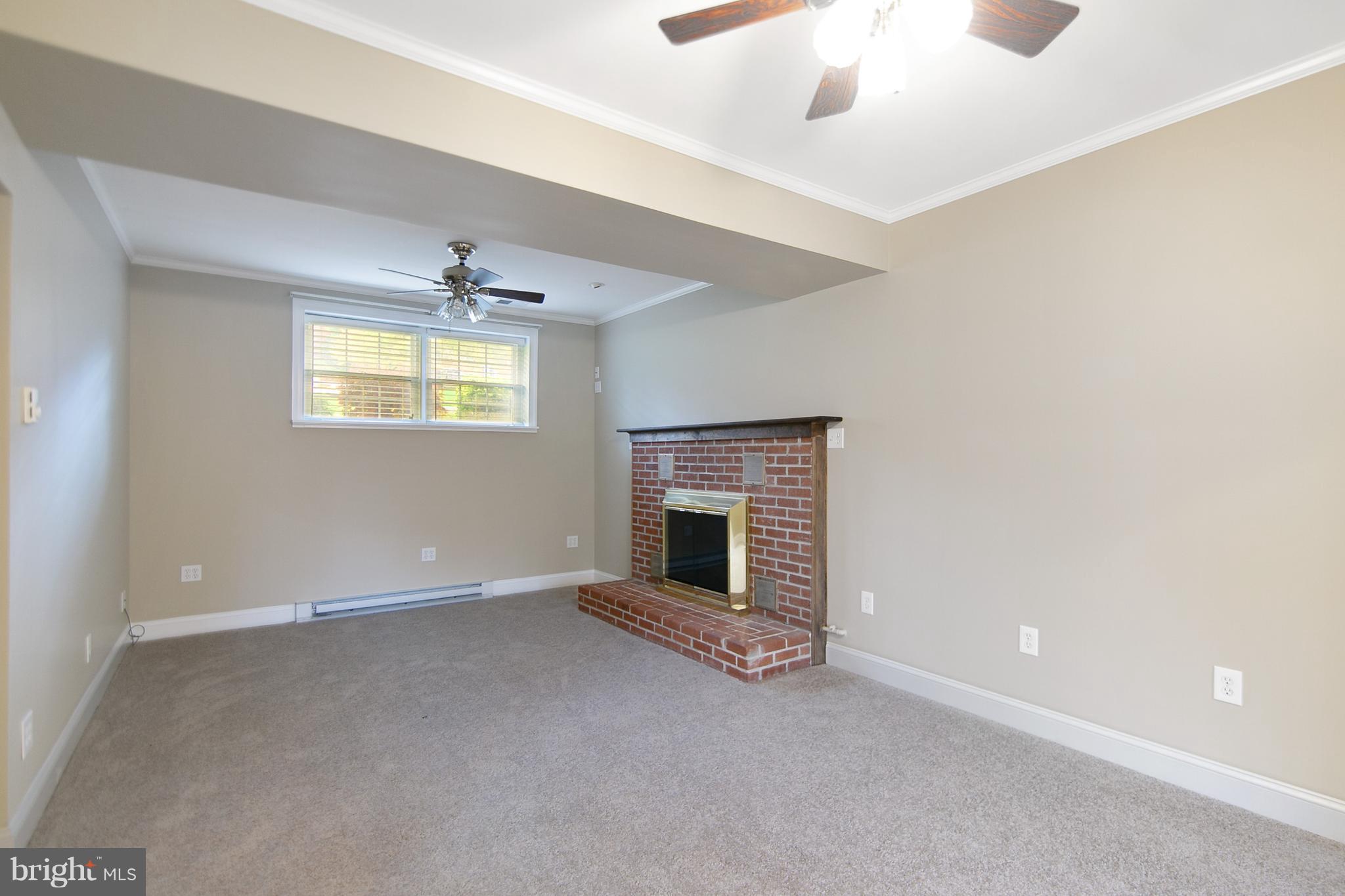 8306 Hollow Road Middletown, MD 21769 - Photo 14 of 37 an empty room with windows and fireplace
