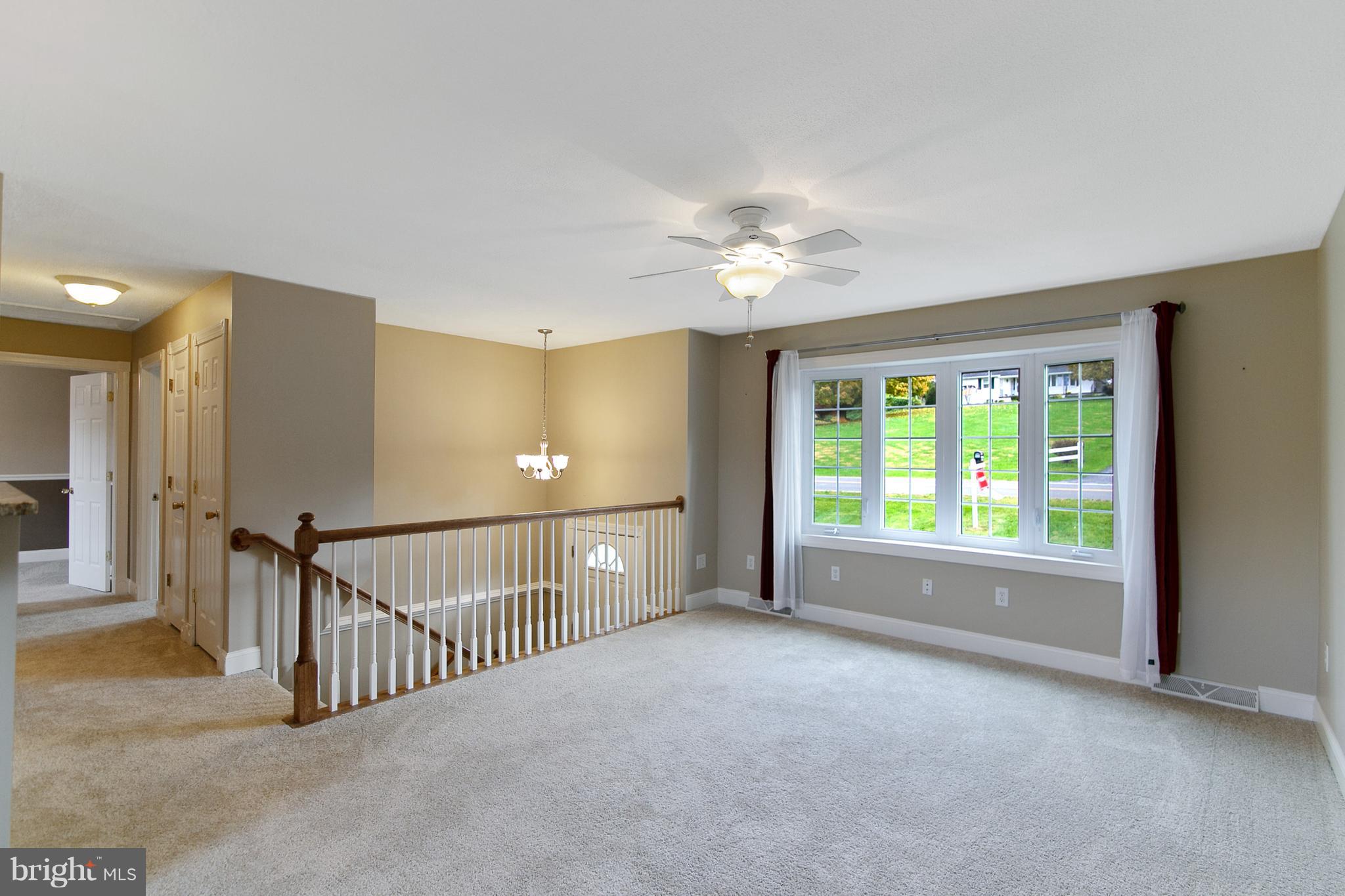 8306 Hollow Road Middletown, MD 21769 - Photo 3 of 37 a view of a livingroom with a ceiling fan and window