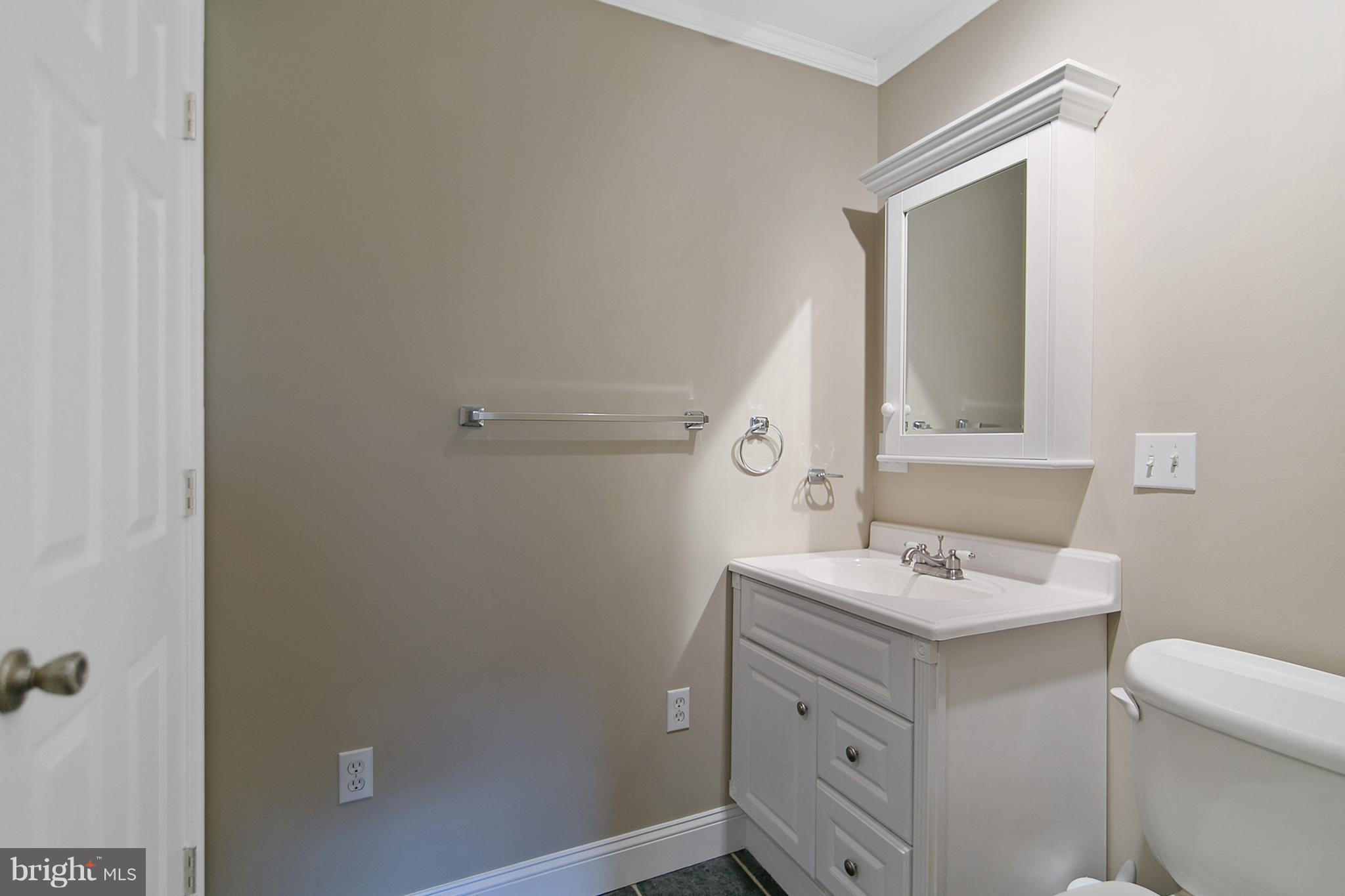 8306 Hollow Road Middletown, MD 21769 - Photo 23 of 37 a bathroom with a sink toilet and mirror
