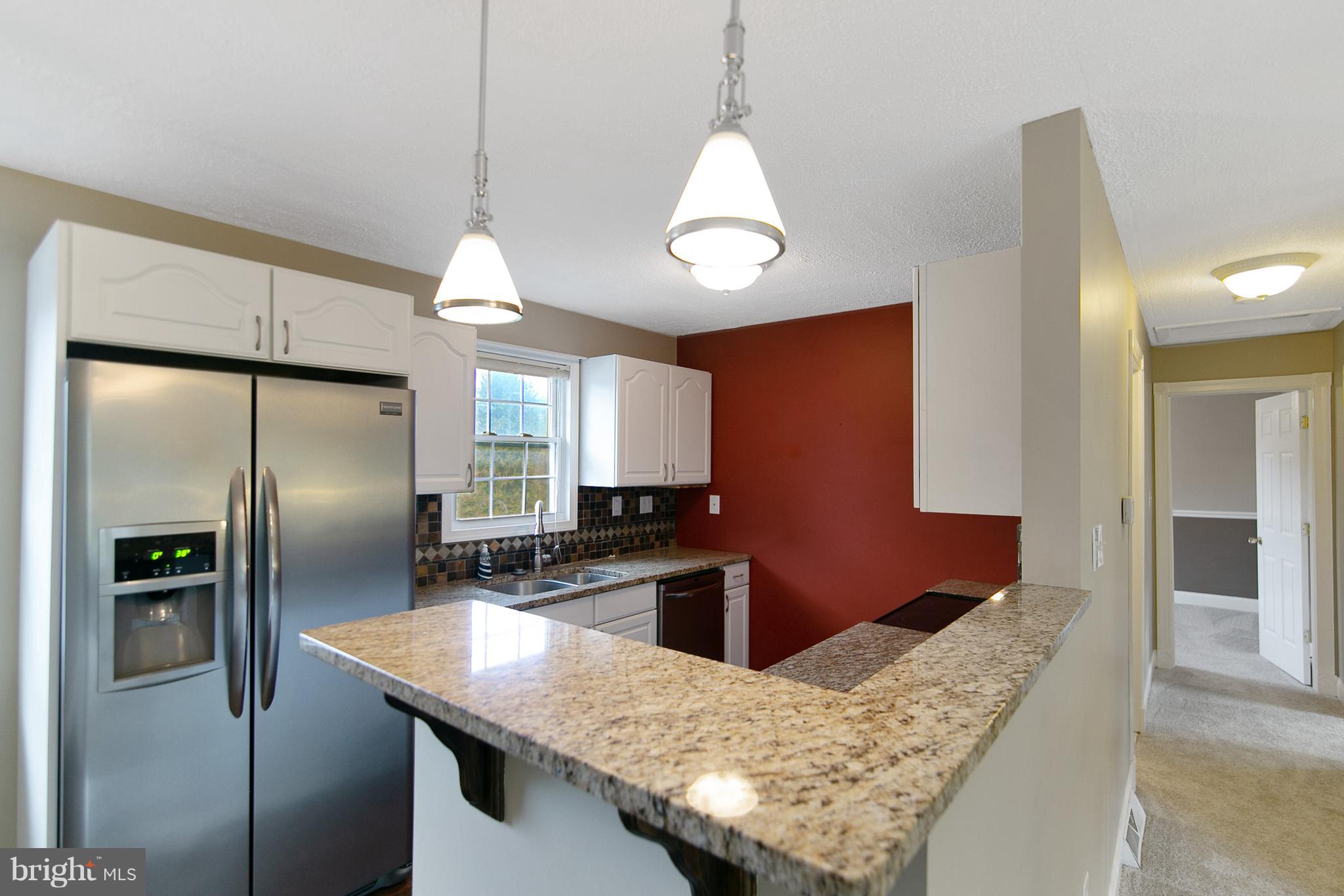 8306 Hollow Road Middletown, MD 21769 - Photo 6 of 37 a kitchen with stainless steel appliances granite countertop a sink refrigerator and microwave