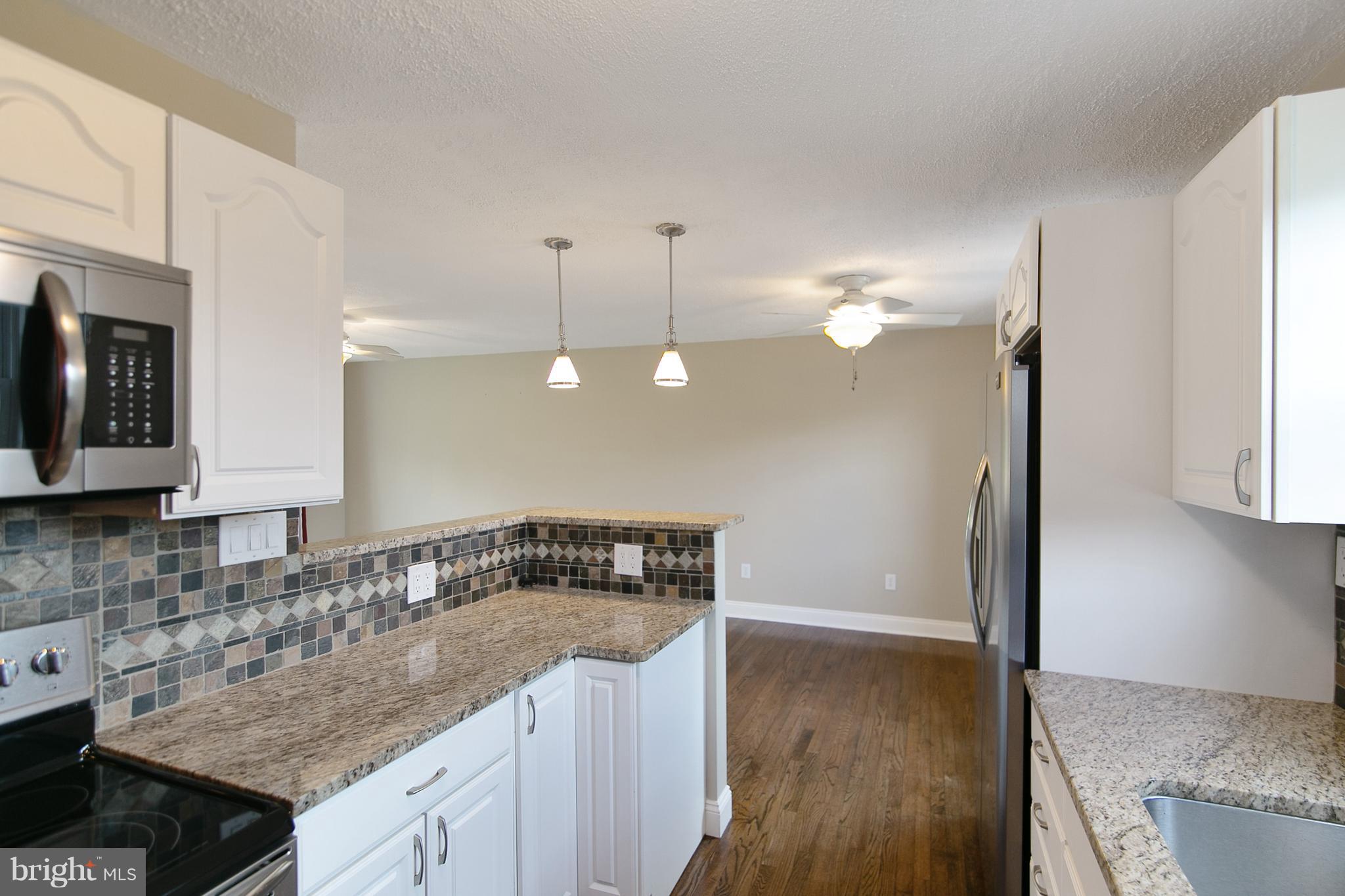 8306 Hollow Road Middletown, MD 21769 - Photo 8 of 37 a kitchen with a sink stove and microwave
