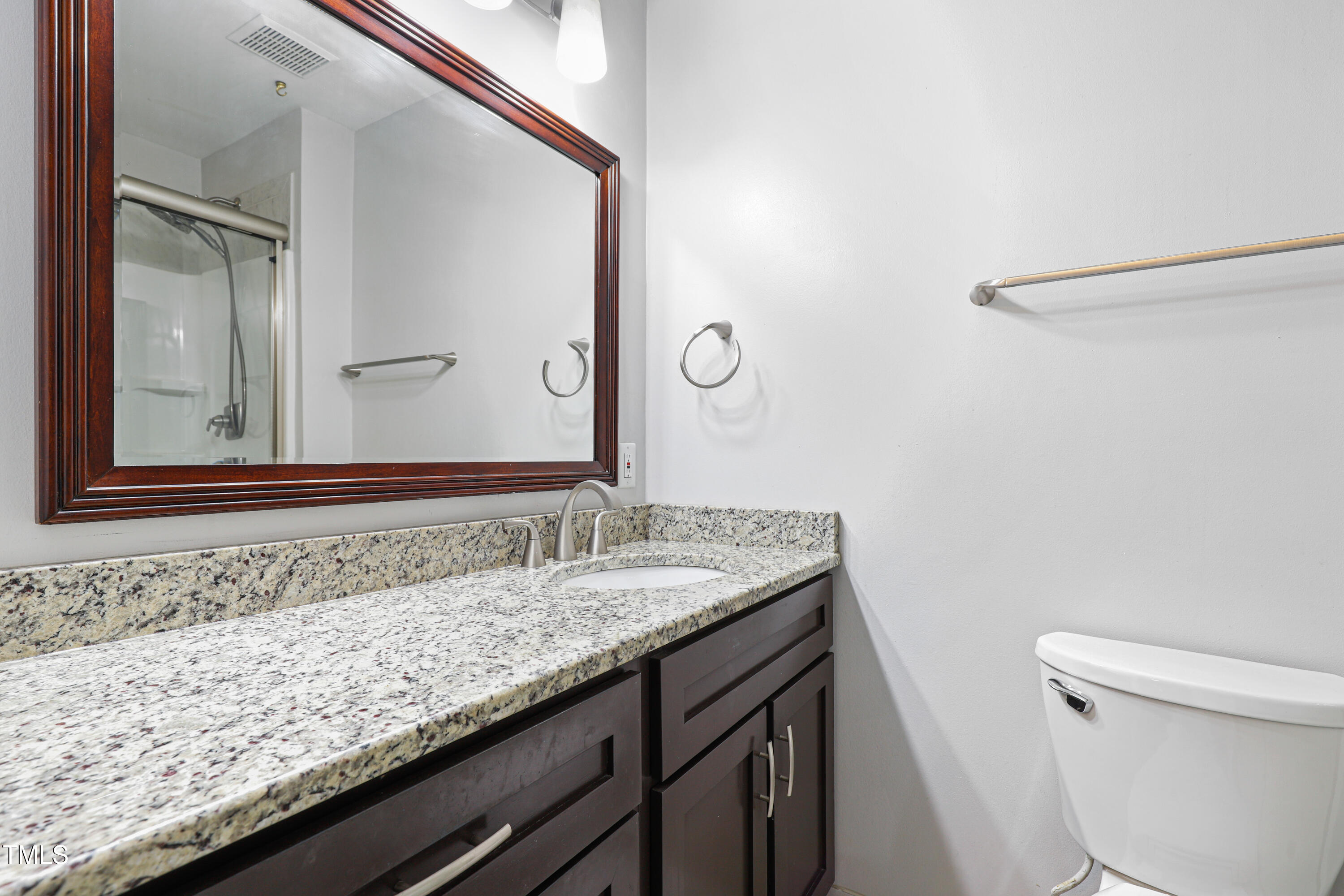 5840 Branchwood Road Raleigh, NC 27609 - Photo 16 of 33 a bathroom with a granite countertop sink and a mirror