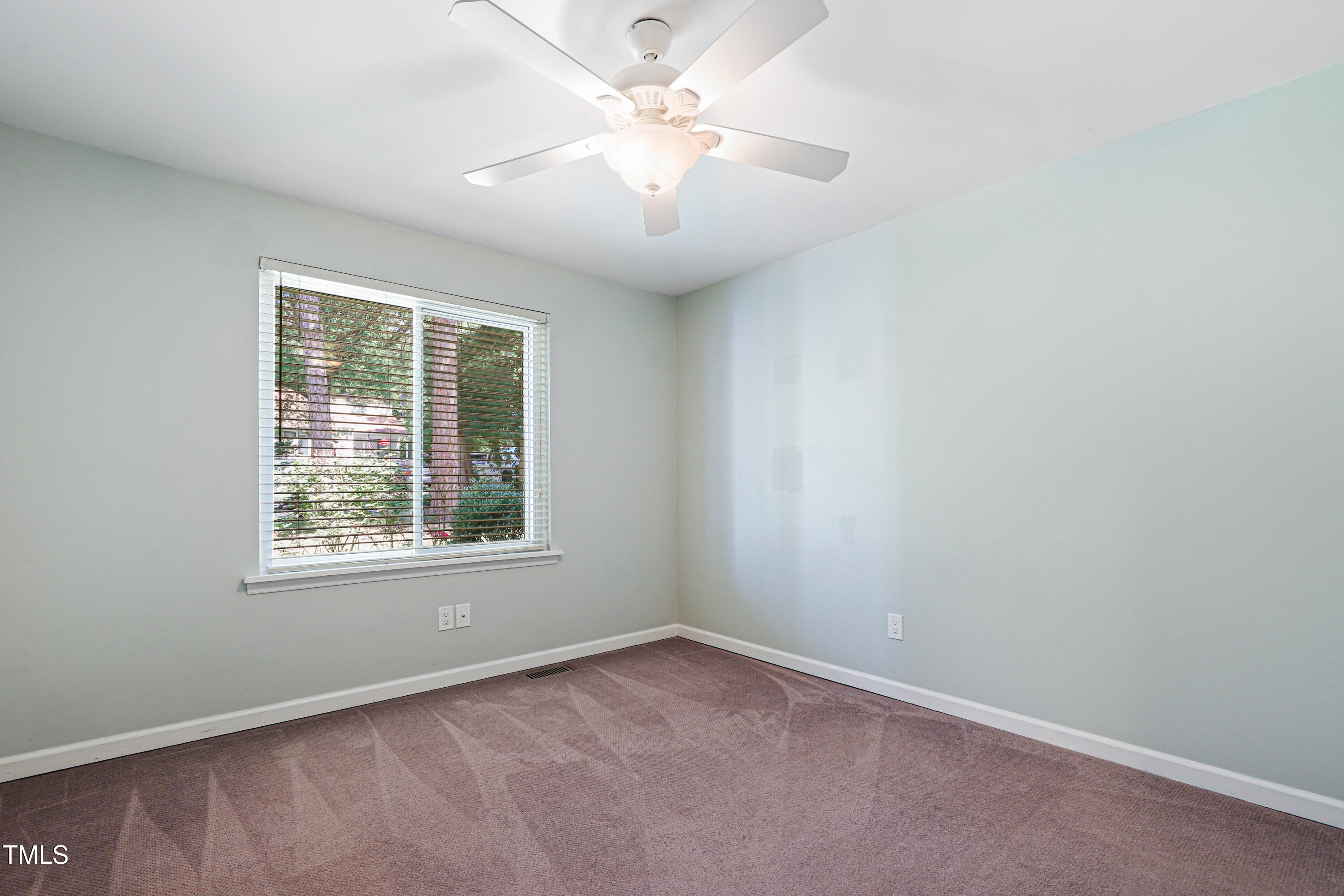 5840 Branchwood Road Raleigh, NC 27609 - Photo 18 of 33 an empty room with a window and a fan