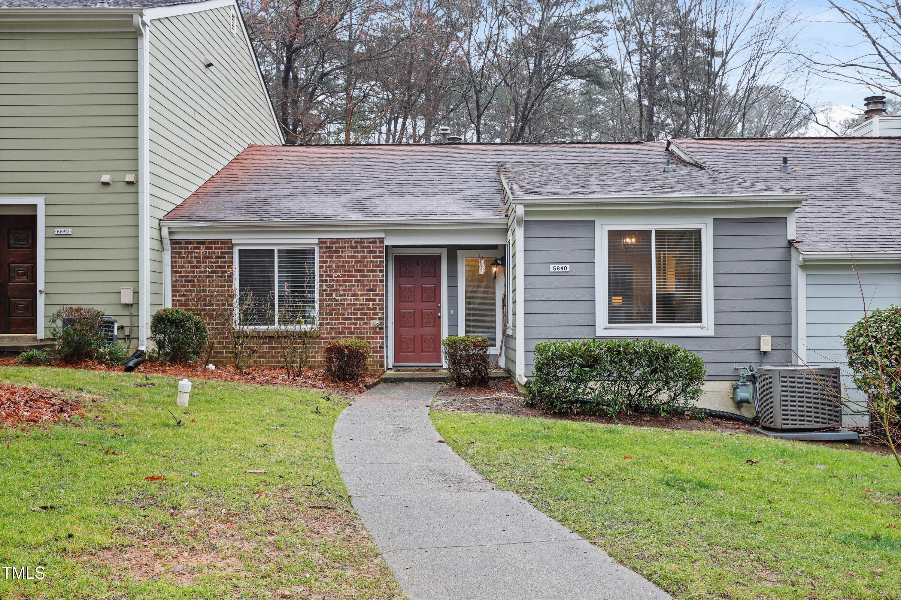 5840 Branchwood Road Raleigh, NC 27609 - Photo 28 of 33 a front view of a house with a yard and potted plants