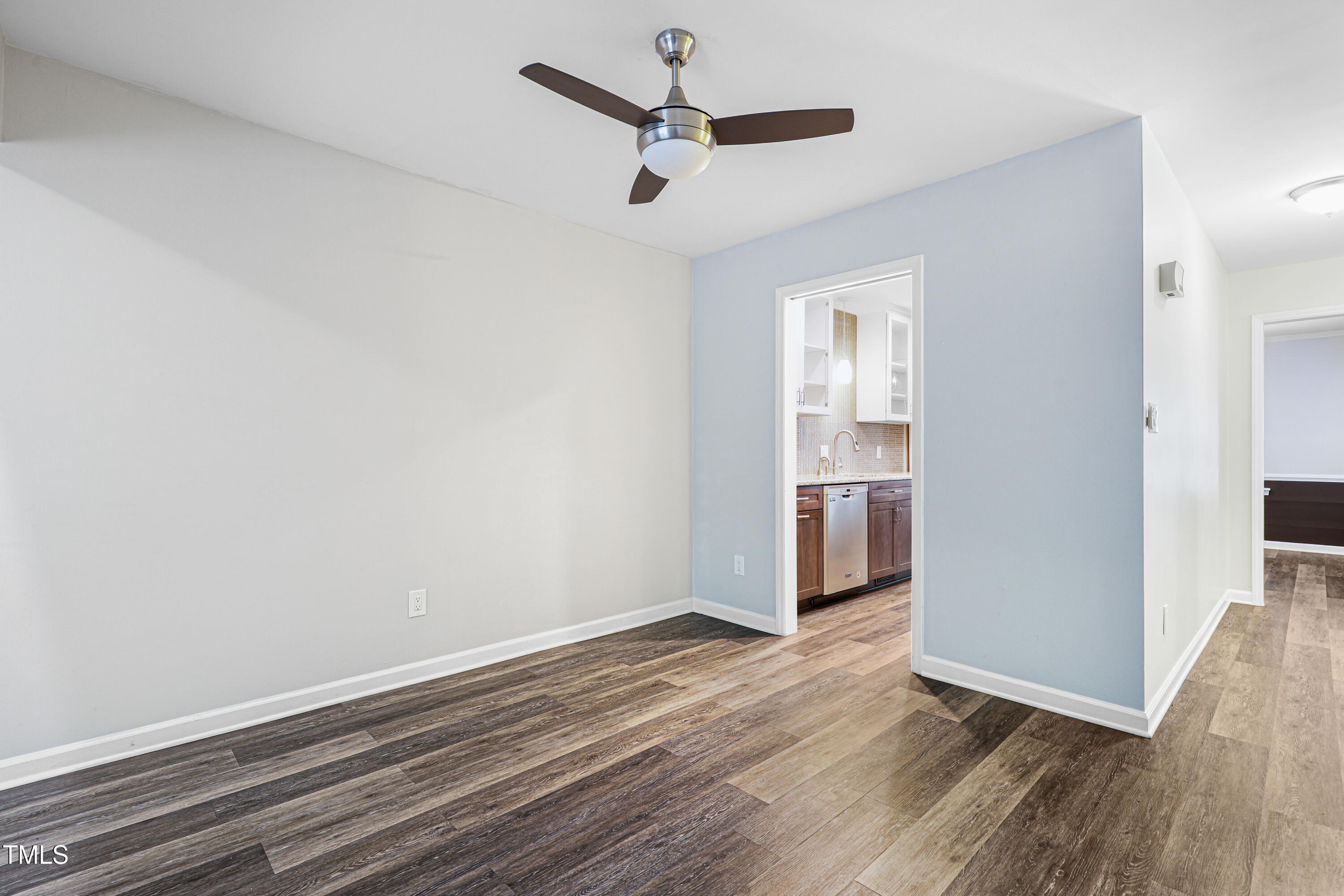 5840 Branchwood Road Raleigh, NC 27609 - Photo 10 of 33 a view of empty room with wooden floor and ceiling fan