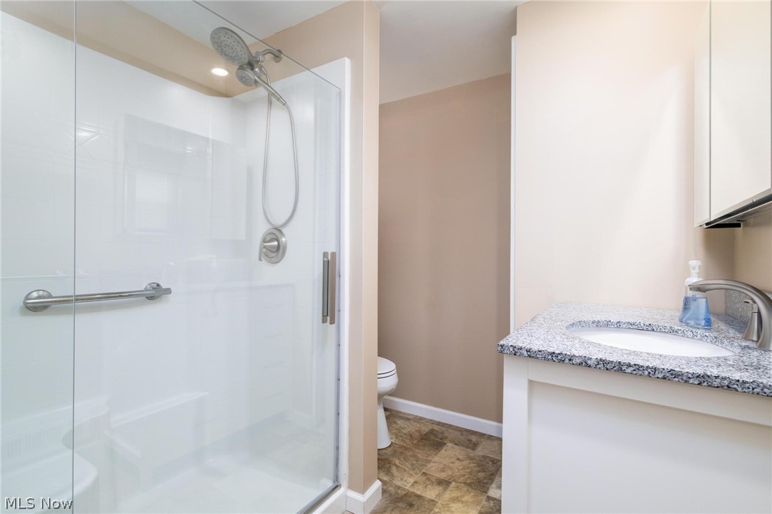 165 9th Street Wellsburg, WV 26070 - Photo 23 of 37 Bathroom featuring vanity, a stall shower, and stone finish flooring