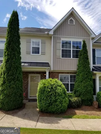 a front view of a house with a garden